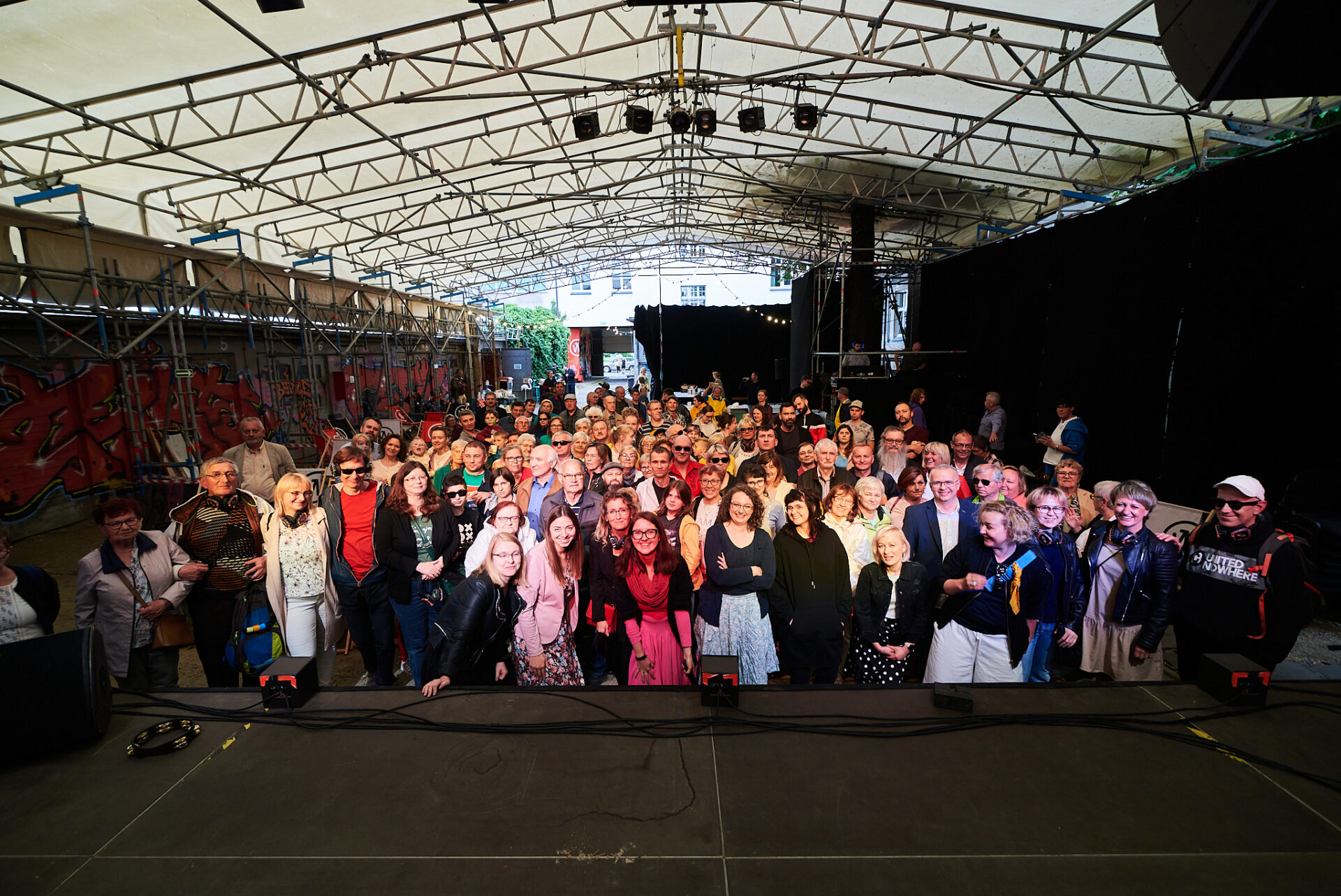 podwórko impartu we wrocławiu. zdjęcie tłumu ludzi zrobione ze sceny. W pierwszym rzędzie pracownicy i współpracownicy Katarynki. Za nimi ponad sto osób - uczestnicy katarynkowych wydarzń.