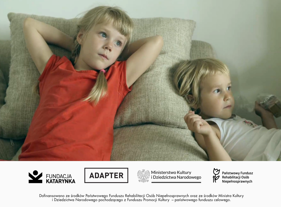 Kolorowy kadr z filmu Kometa. Dwie dziewczynki leżą na kanapie. Poniżej logotypy: Fundacja Katarynka, Adapter, Ministerstwo Kultury i Dziedzictwa Narodowego, Państwowy Fundusz Rehabilitacji Osób Niepełnosprawnych. Poniżej napis: Dofinansowano ze środków Państwowego Funduszu Rehabilitacji Osób Niepełnosprawnych oraz ze środków Ministra Kultury i Dziedzictwa Narodowego pochodzącego z Funduszu Promocji Kultury - państwowego funduszu celowego. 